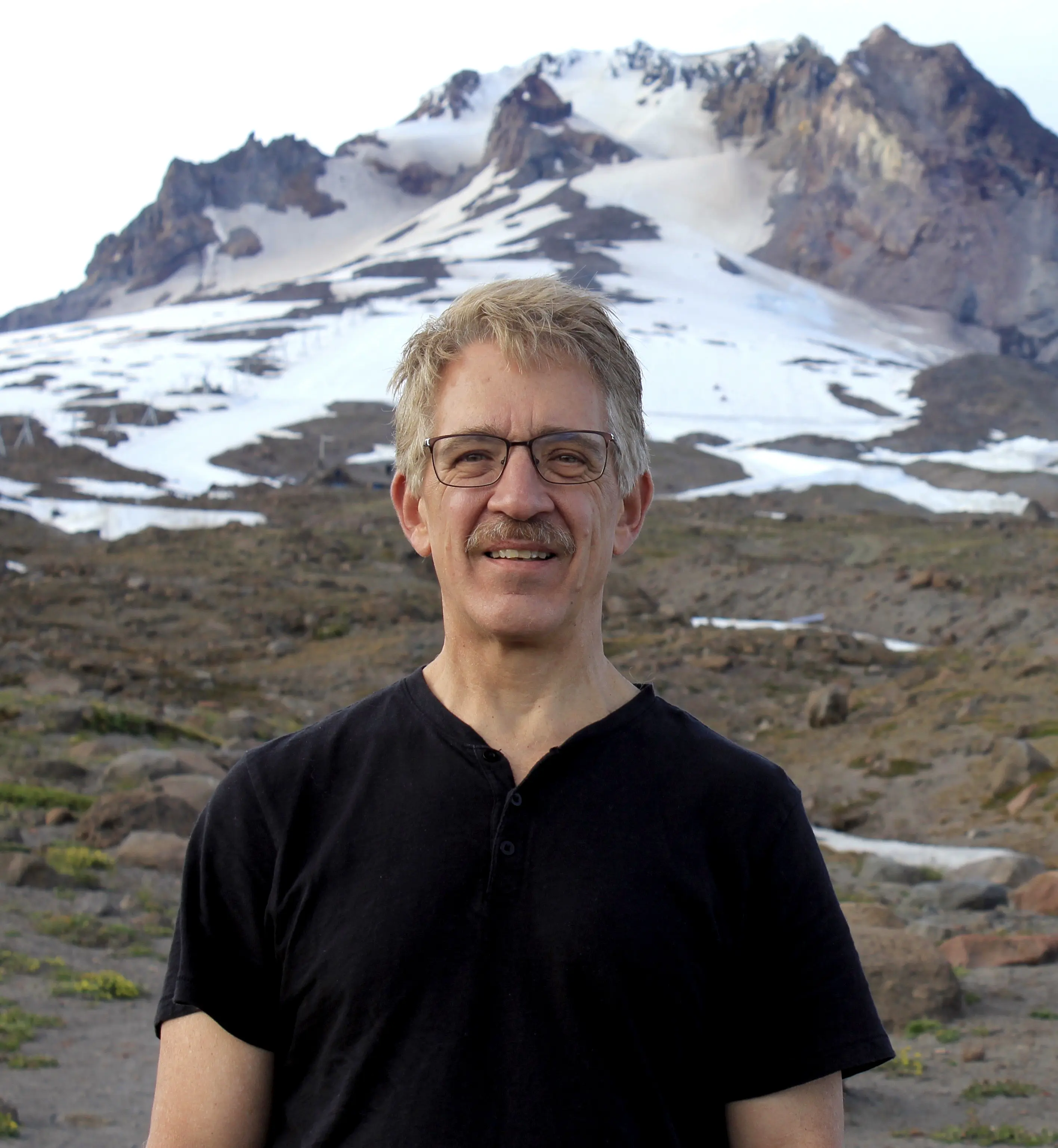 Ken Parsons standing at the base of a mountain
