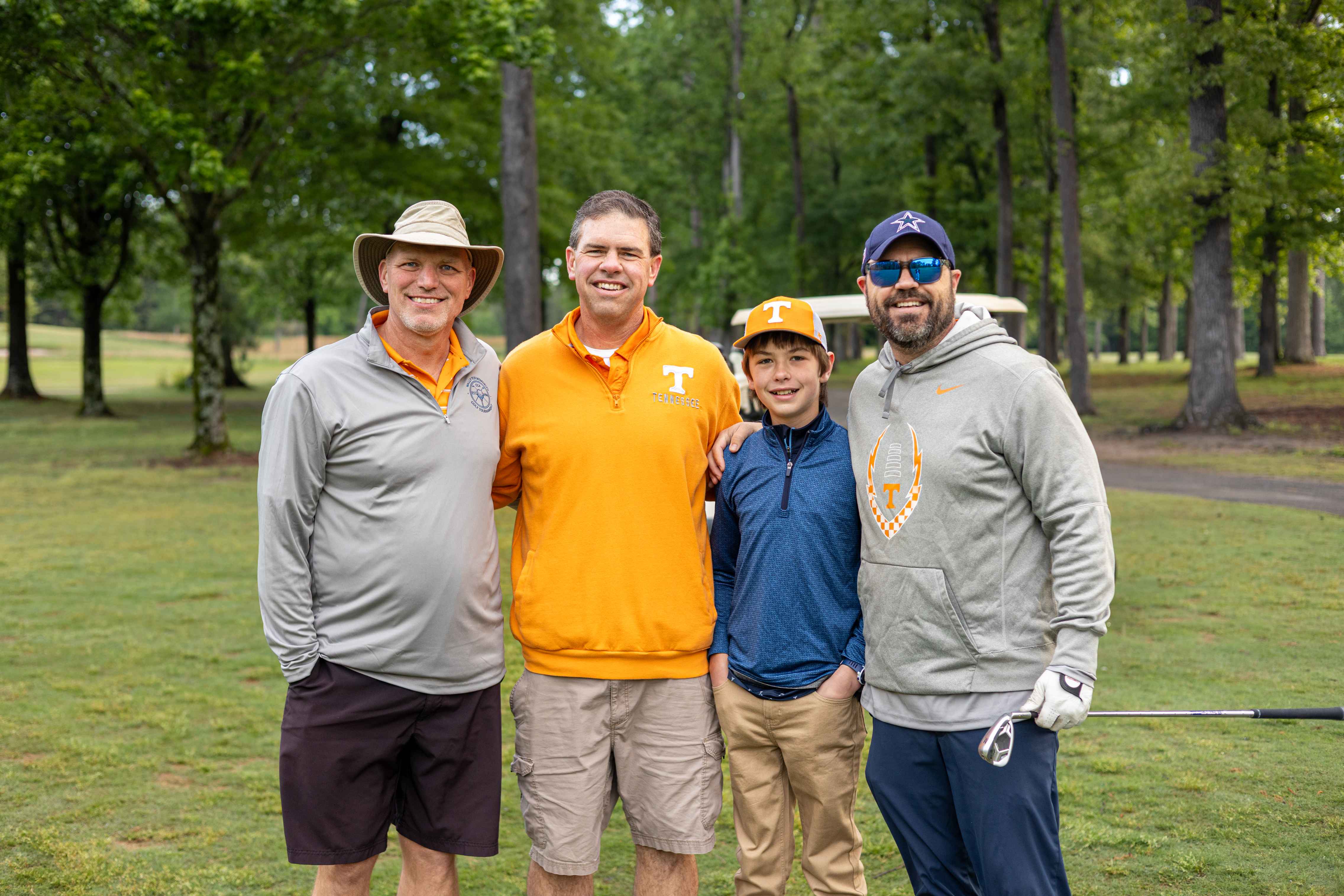 four golfers posing 