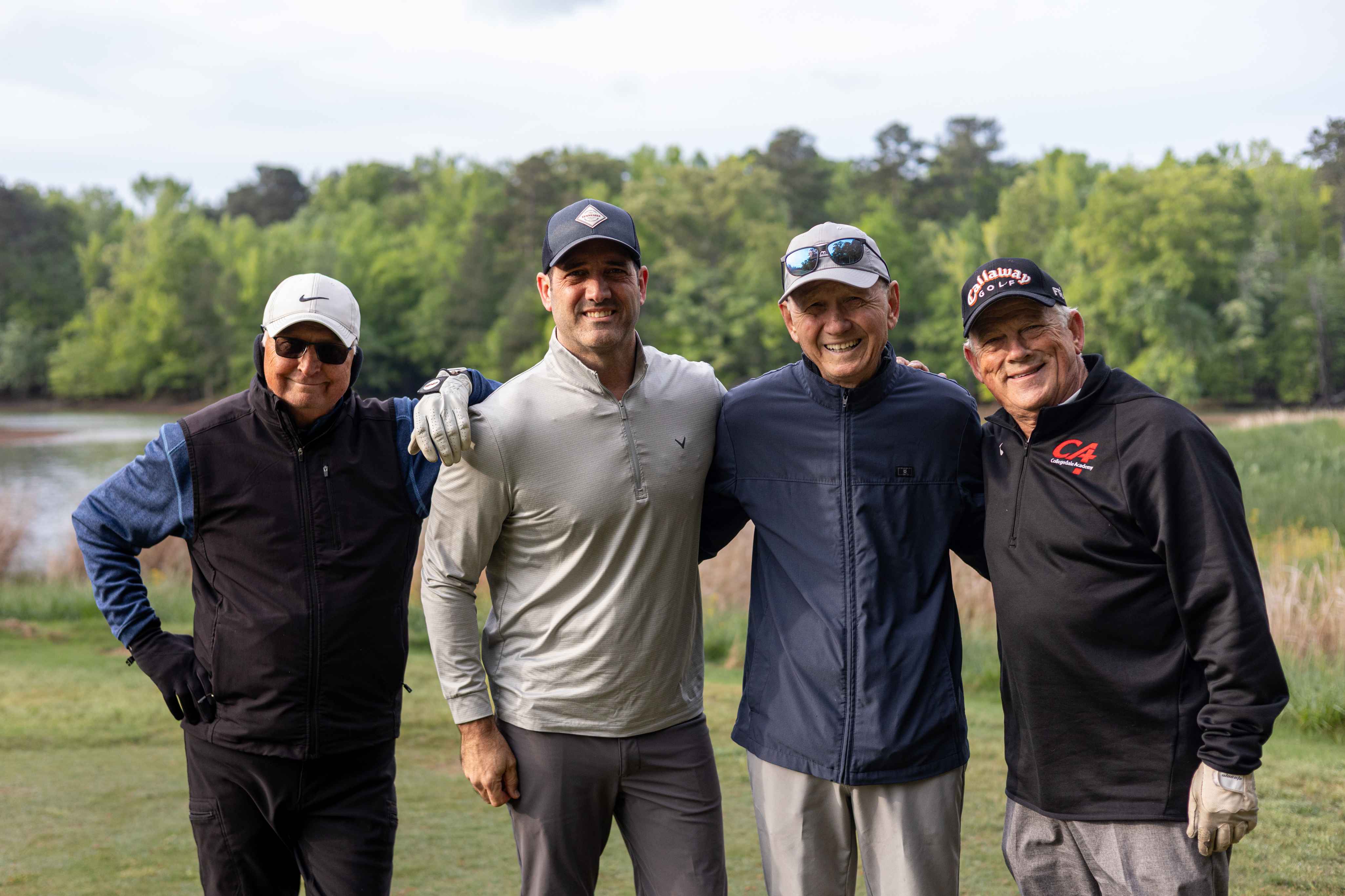 four golfers posing 