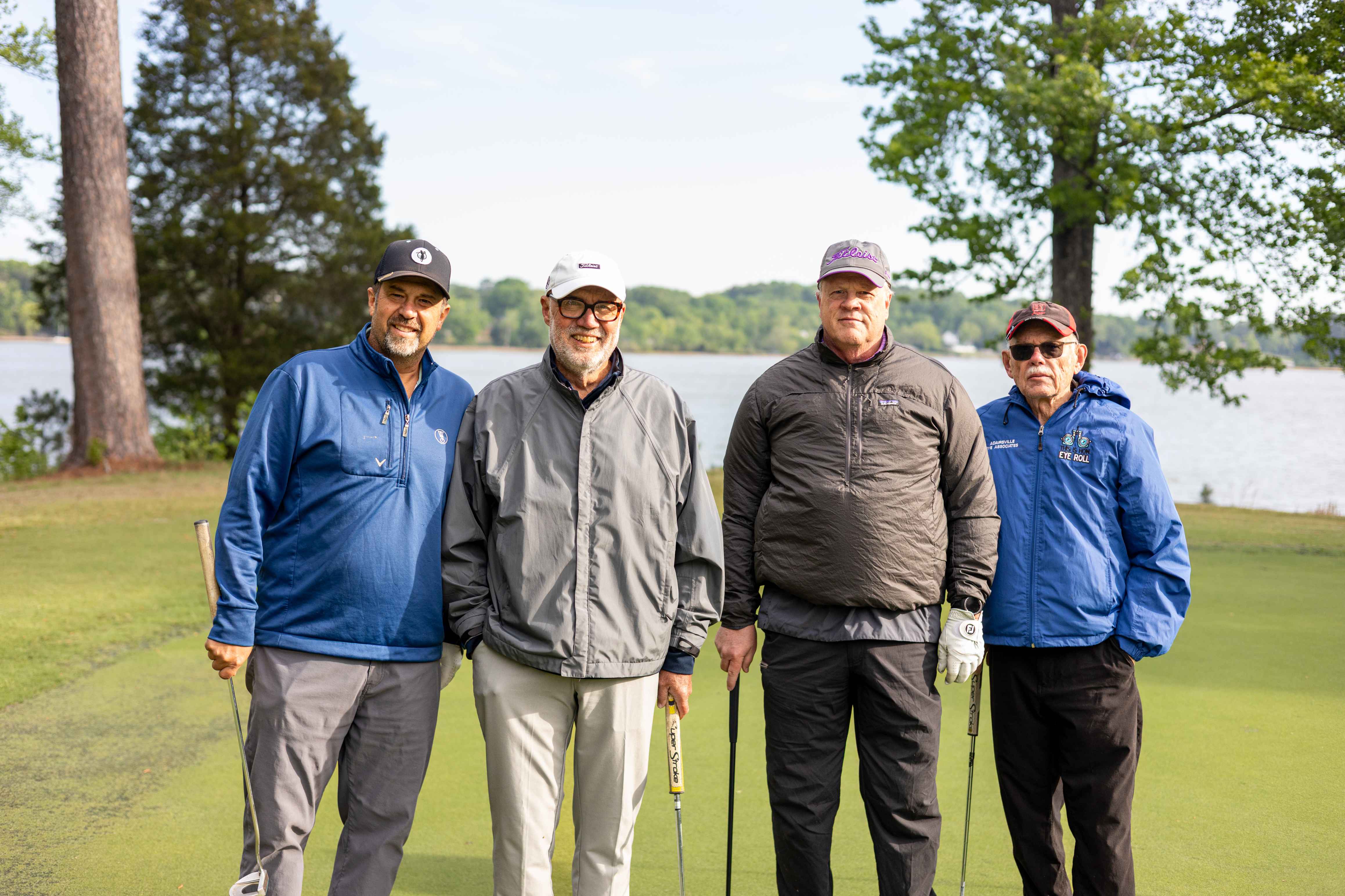 four golfers posing 