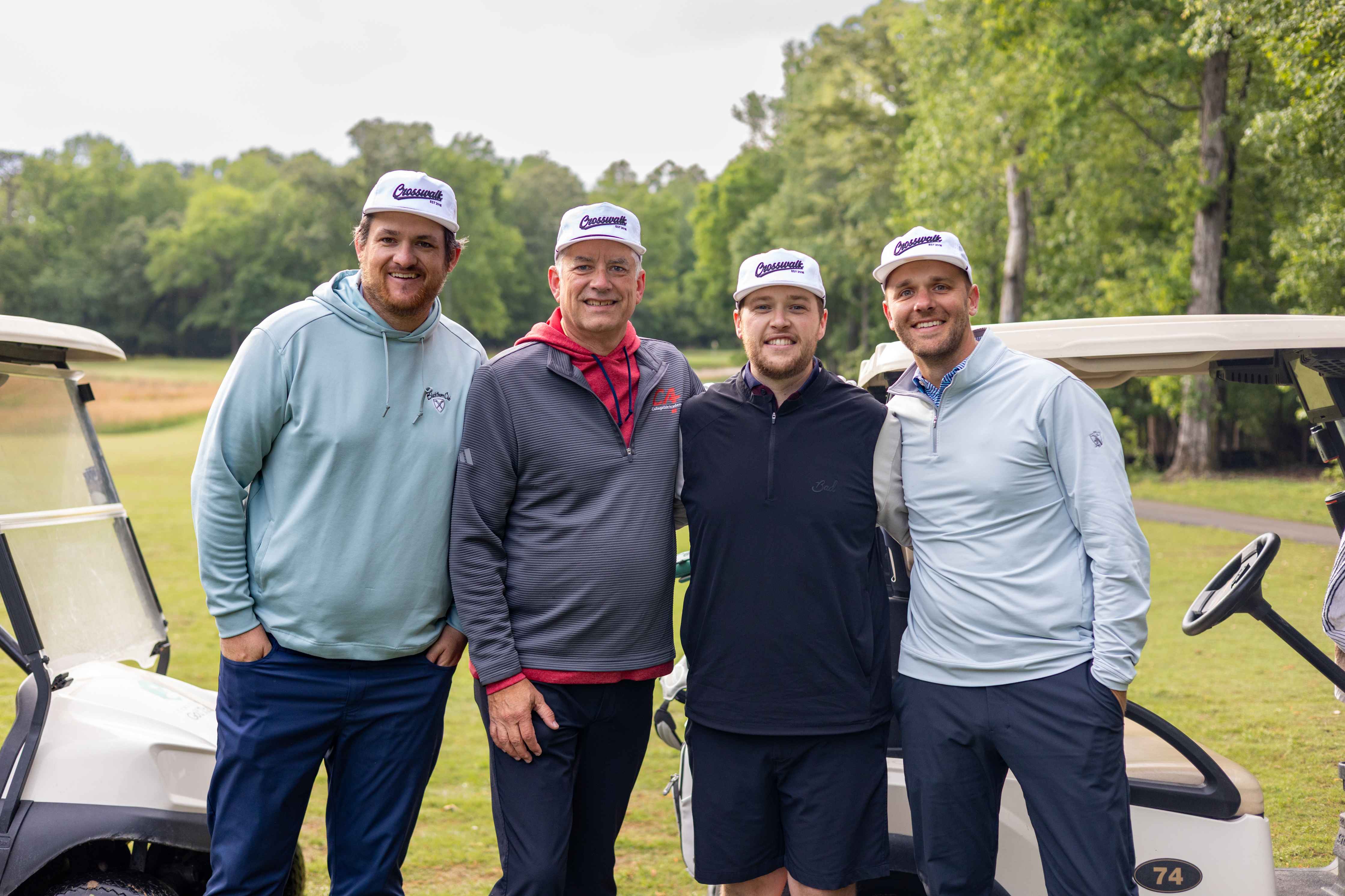 four golfers posing 
