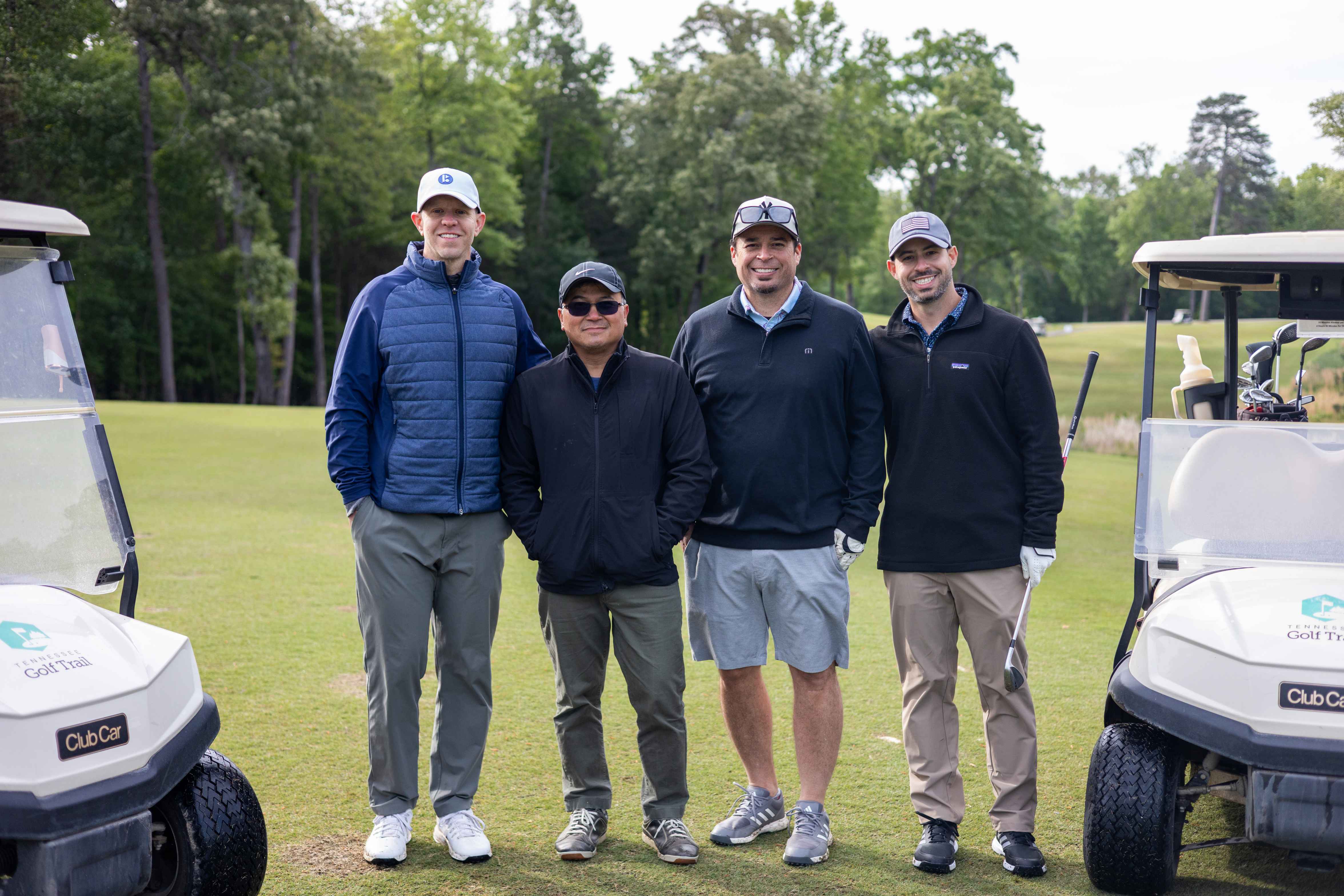 four golfers posing 