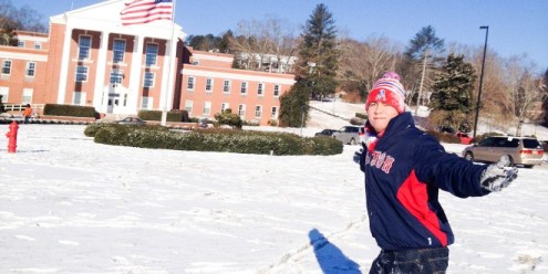 A student posing in the snow