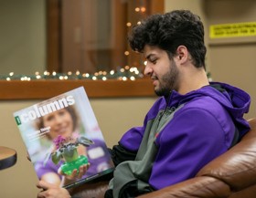 Student reading Columns magazine