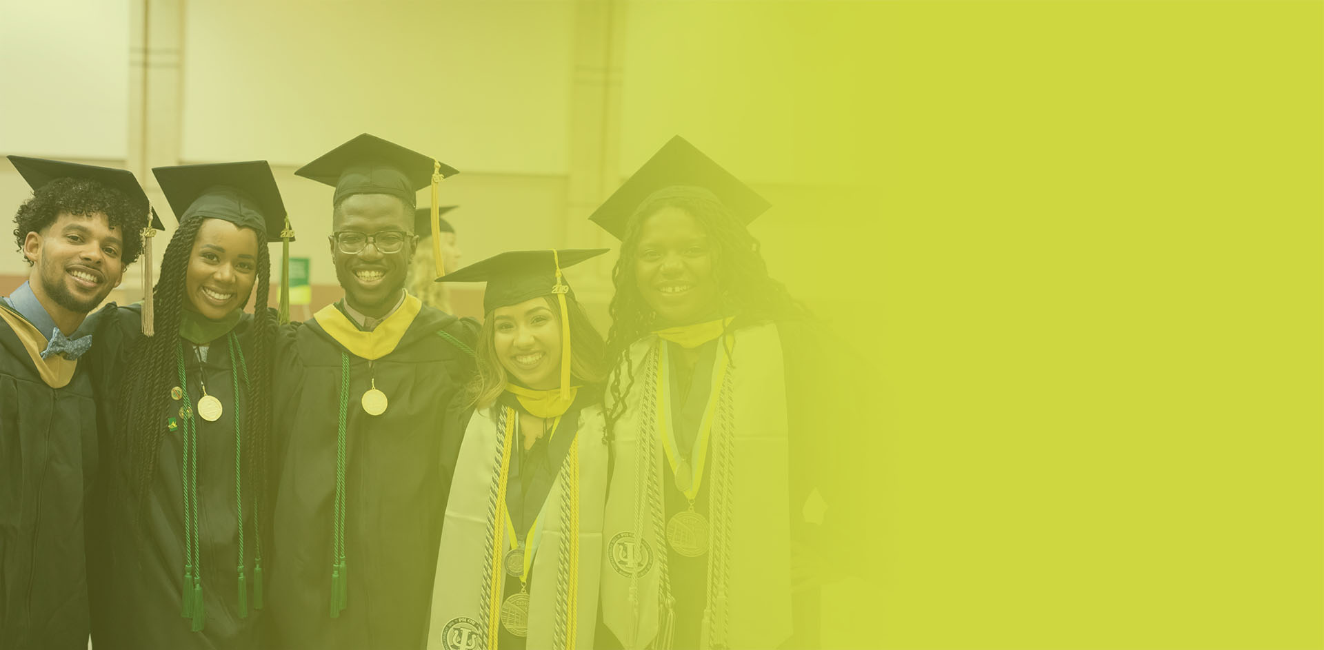 Graduates celebrating together in academic regalia following commencement ceremony