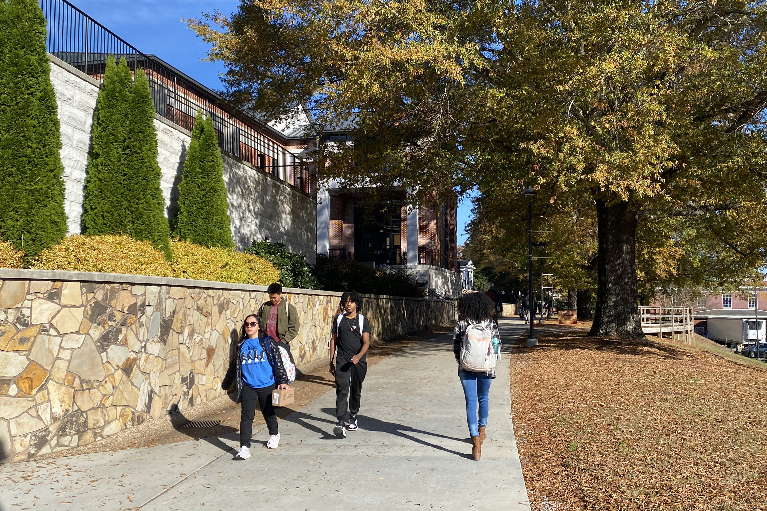 students walk along the promenade