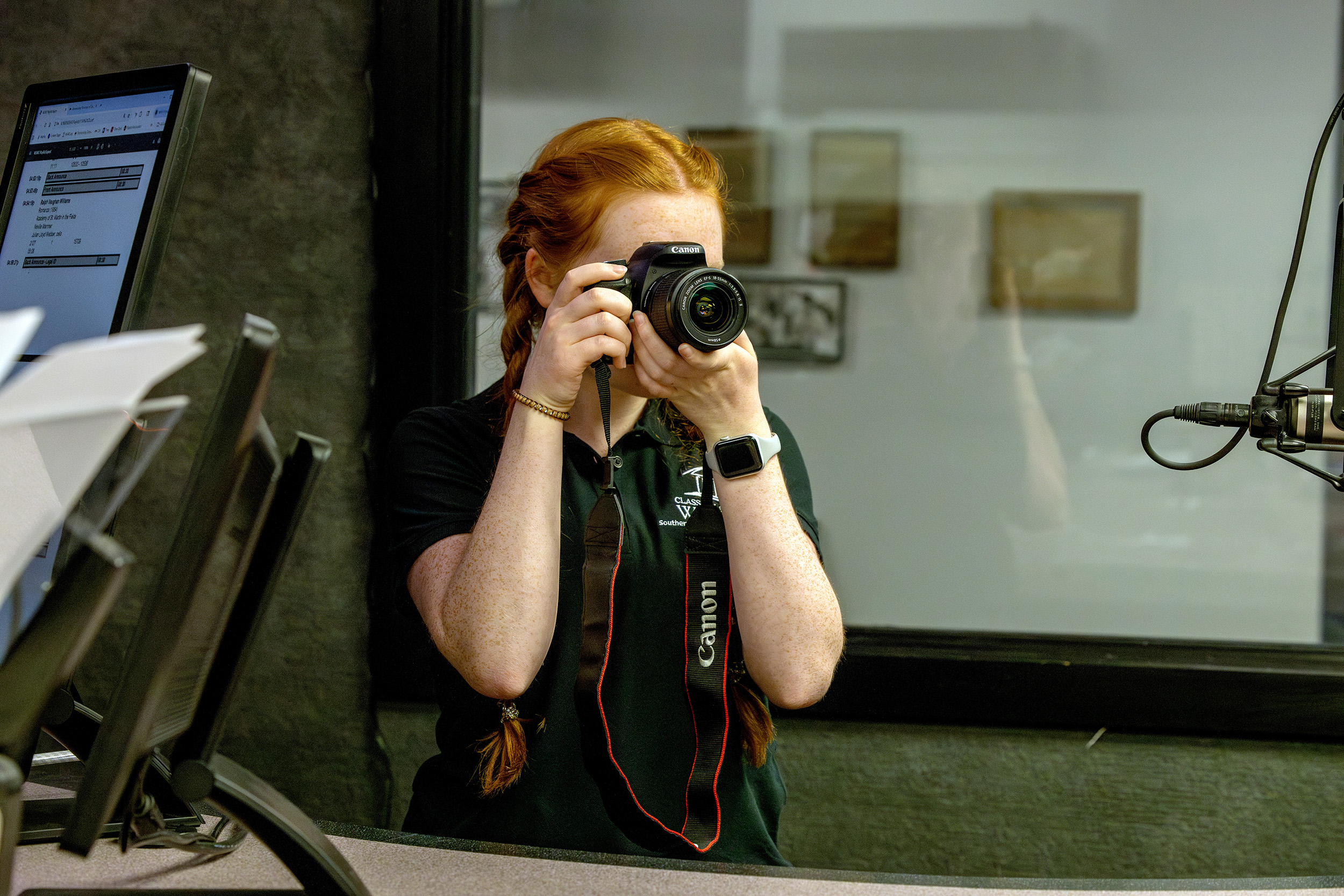 a student holds up a camera for a photo