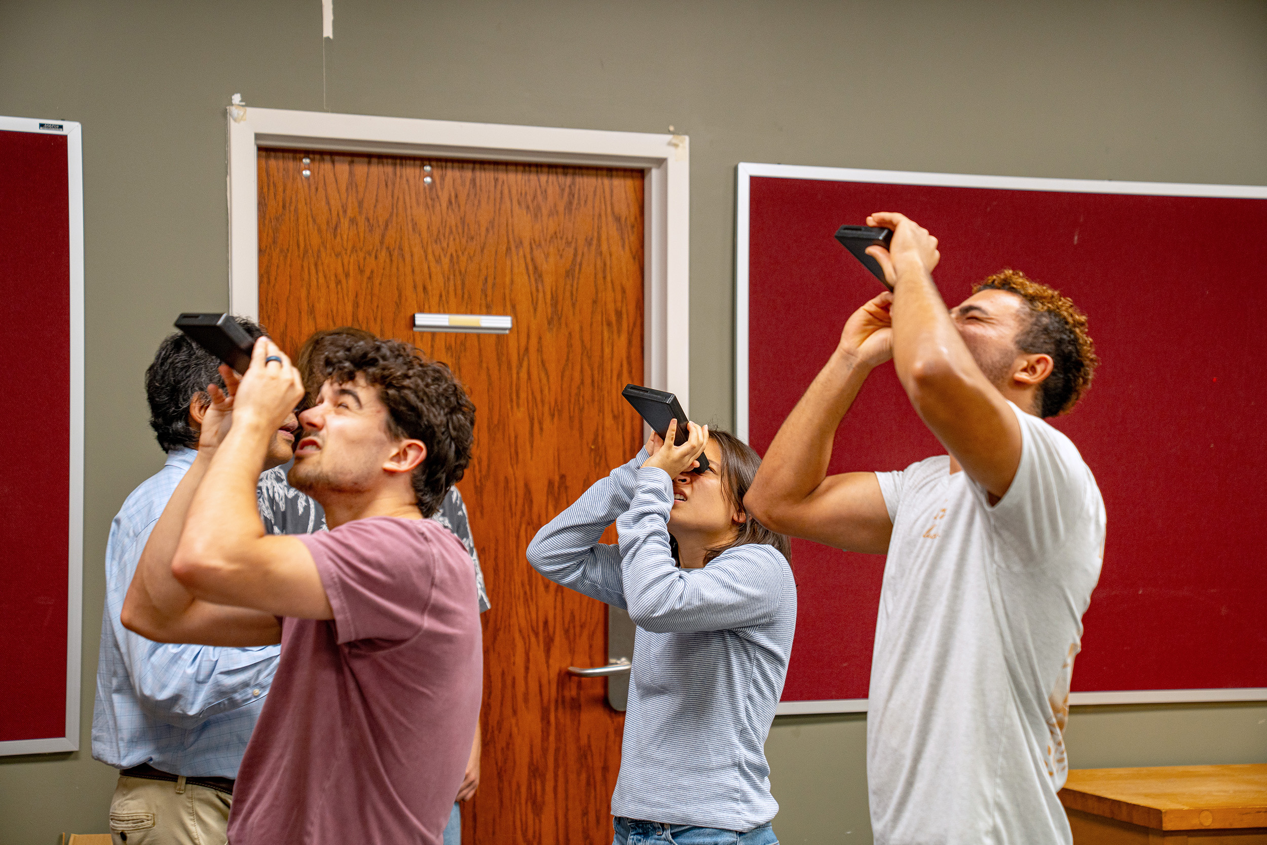 students in a classroom look up through viewers