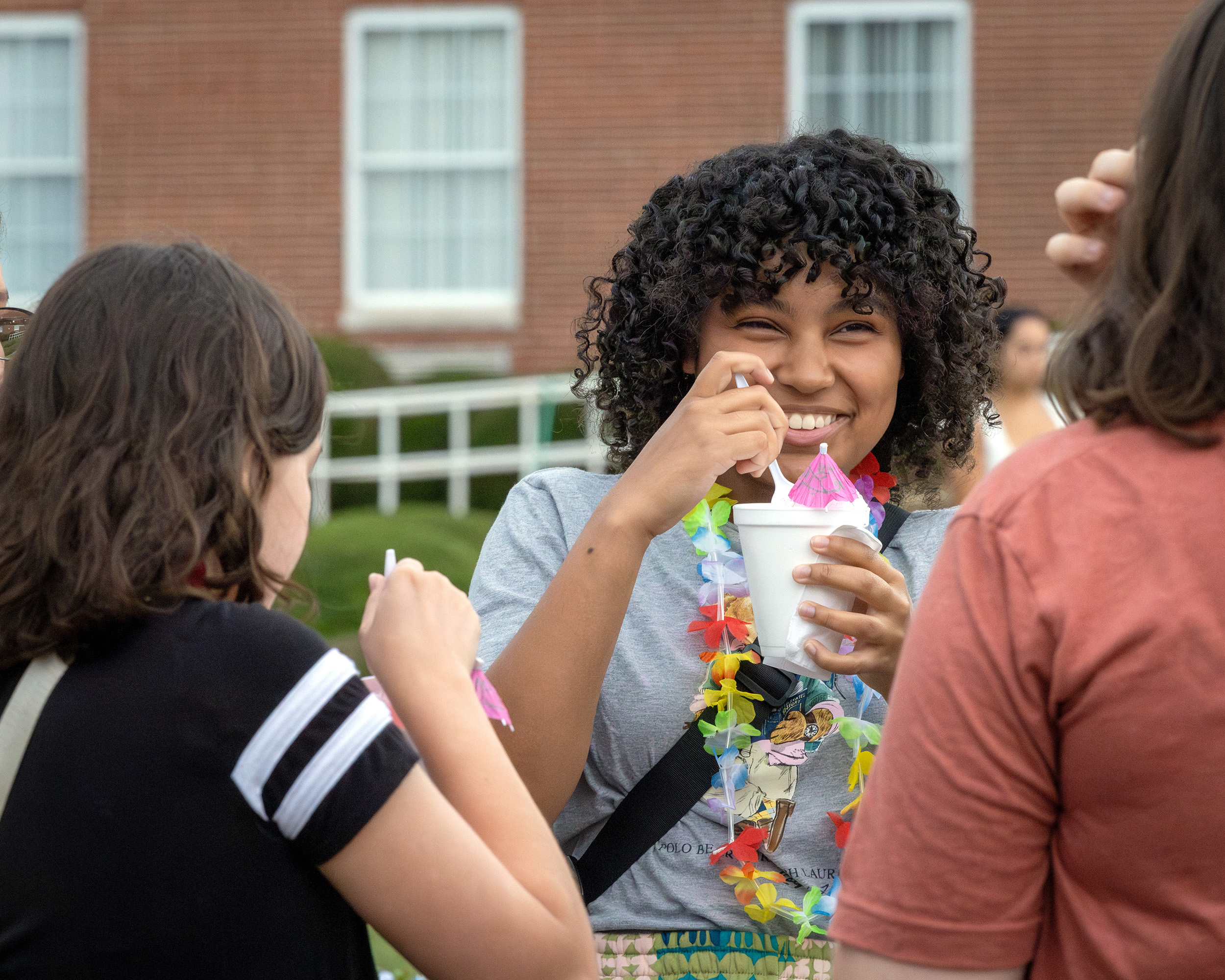 students smile and drink slushies