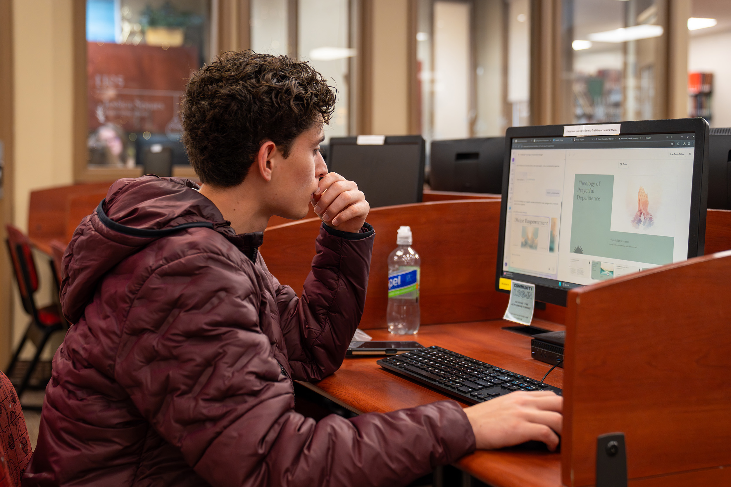 student on a computer in the library