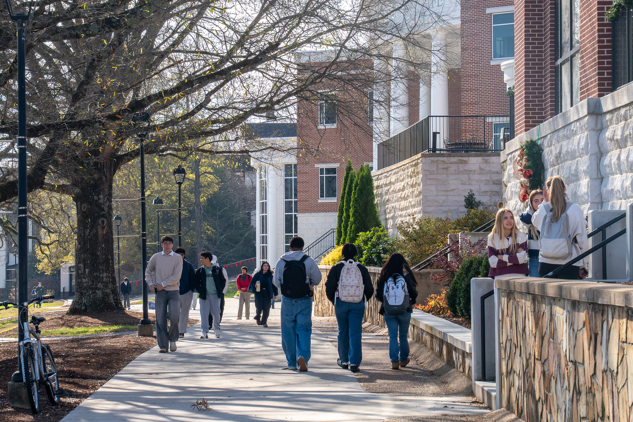 students walk along the promenade