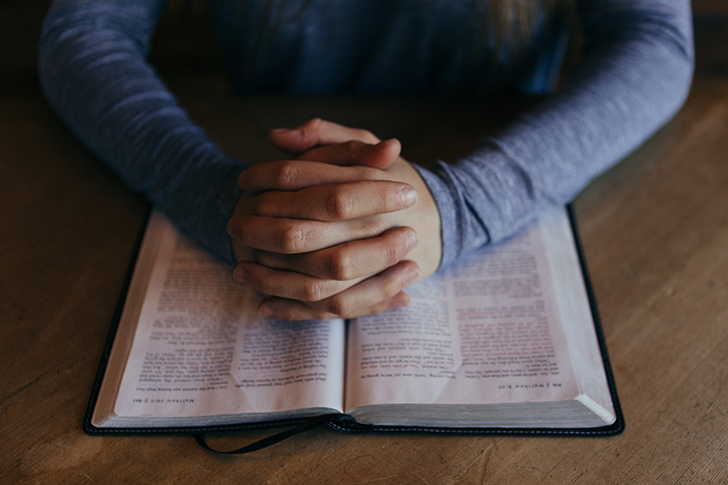 Person Praying With Bible
