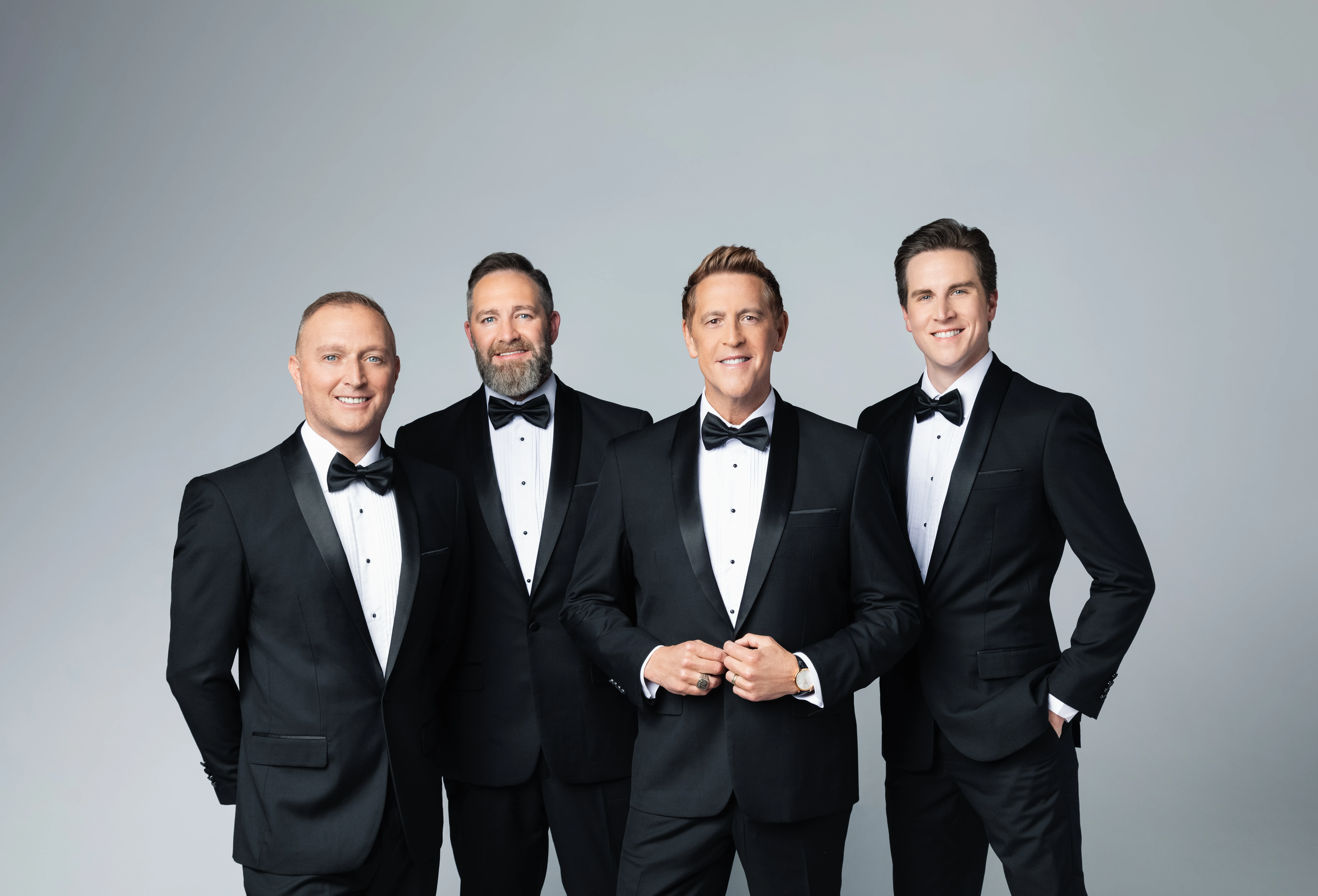 Earnie Haase and the other three members of Signature Sound posing in tuxedos