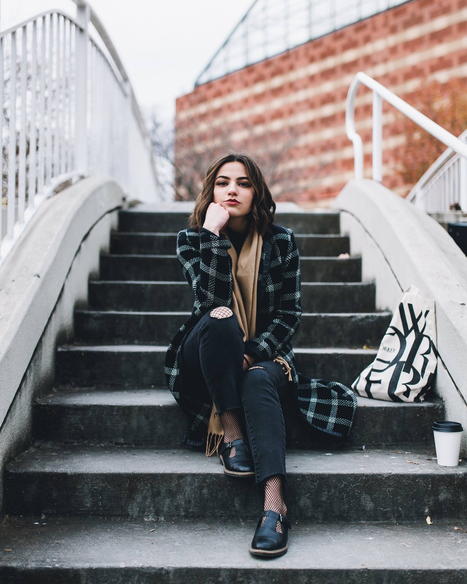 petite brunette sitting on ootdoor steps