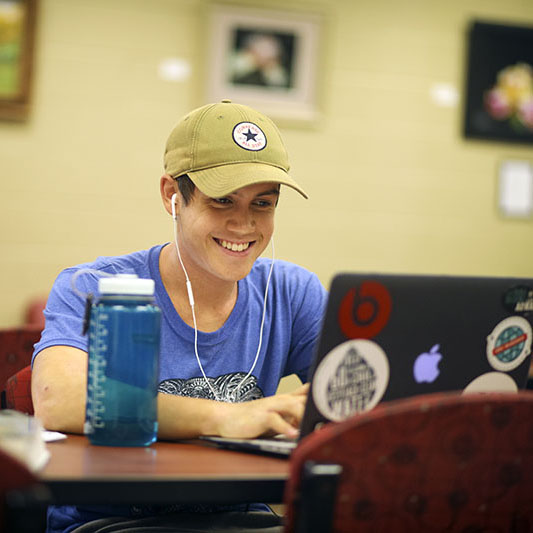 Happy student at laptop