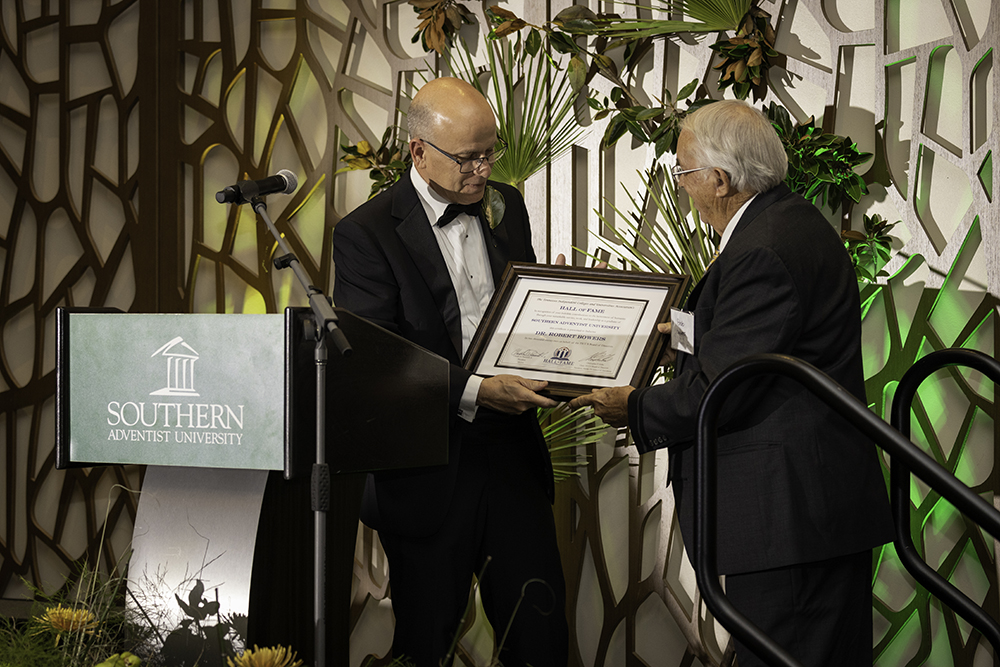Robert Bowers (right) receives recognition as a TICUA Hall of Fame inductee from Southern President Ken Shaw.
