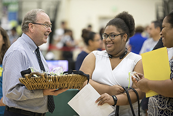 President Smith greets new students with a smile and cookies
