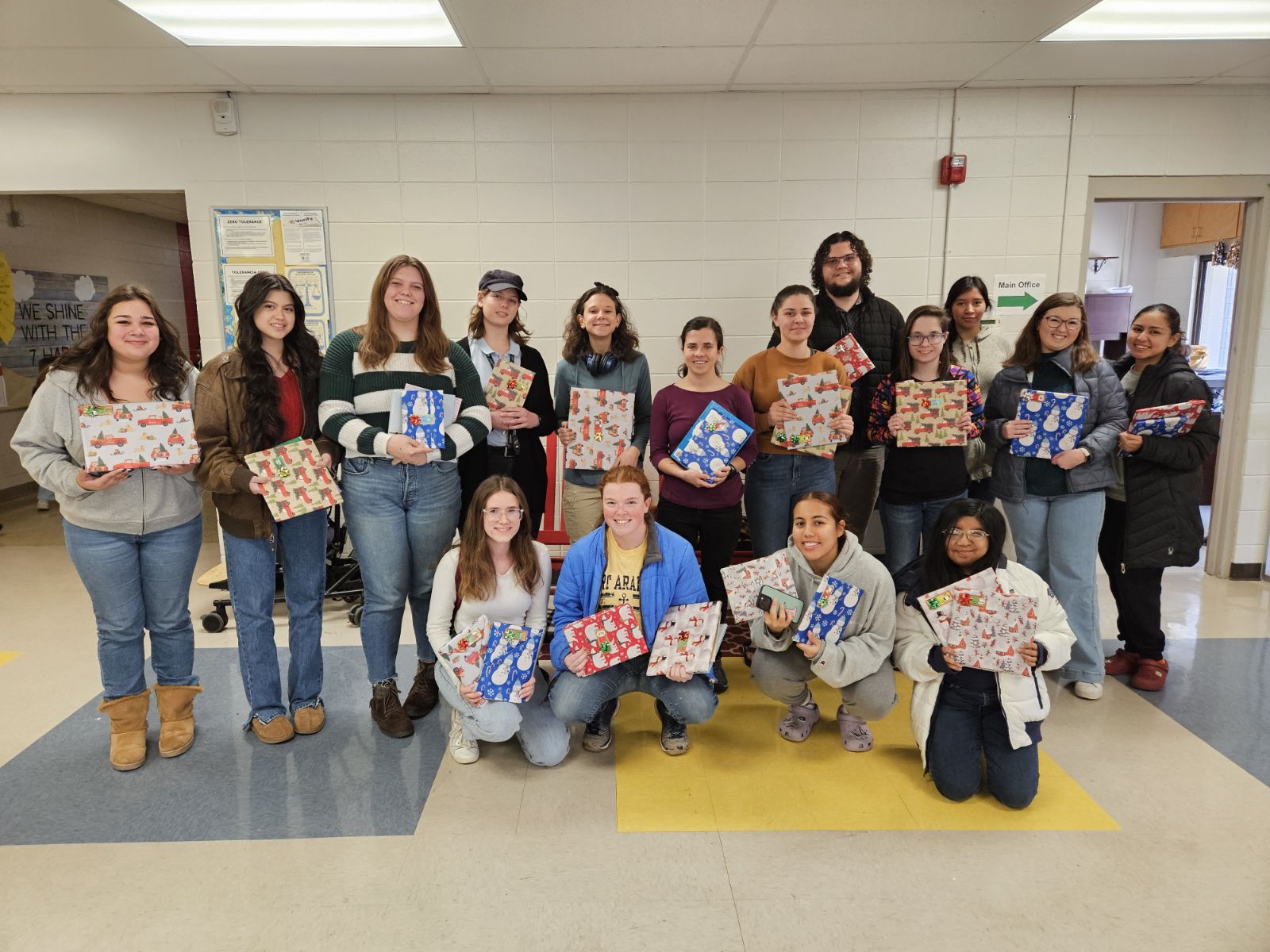 Southern students hold wrapped books to give to first graders at Wolftever Elementary.