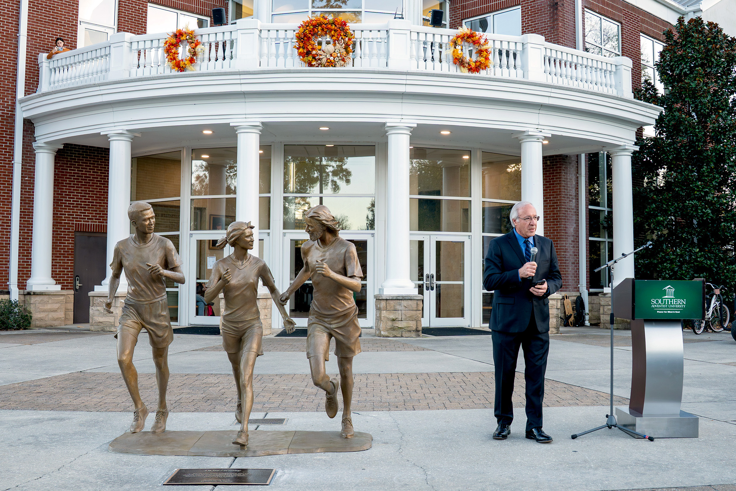 Sculptor Victor Issa speaks about the art installation during the unveiling ceremony on November 6.